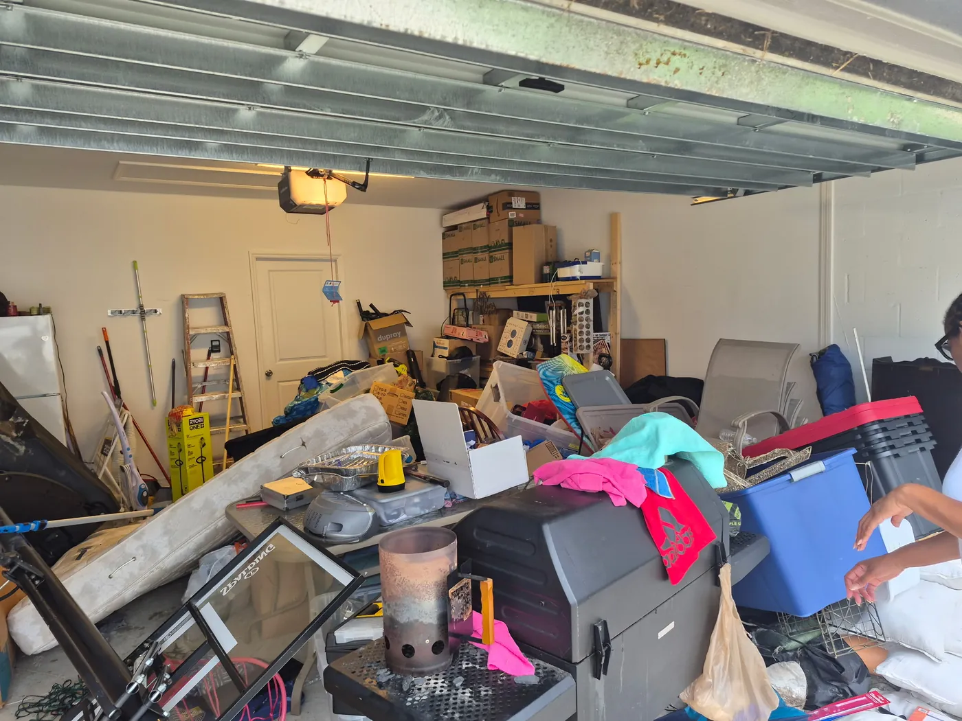 Garage cleanout before in Tampa Bay, FL — a packed, cluttered garage