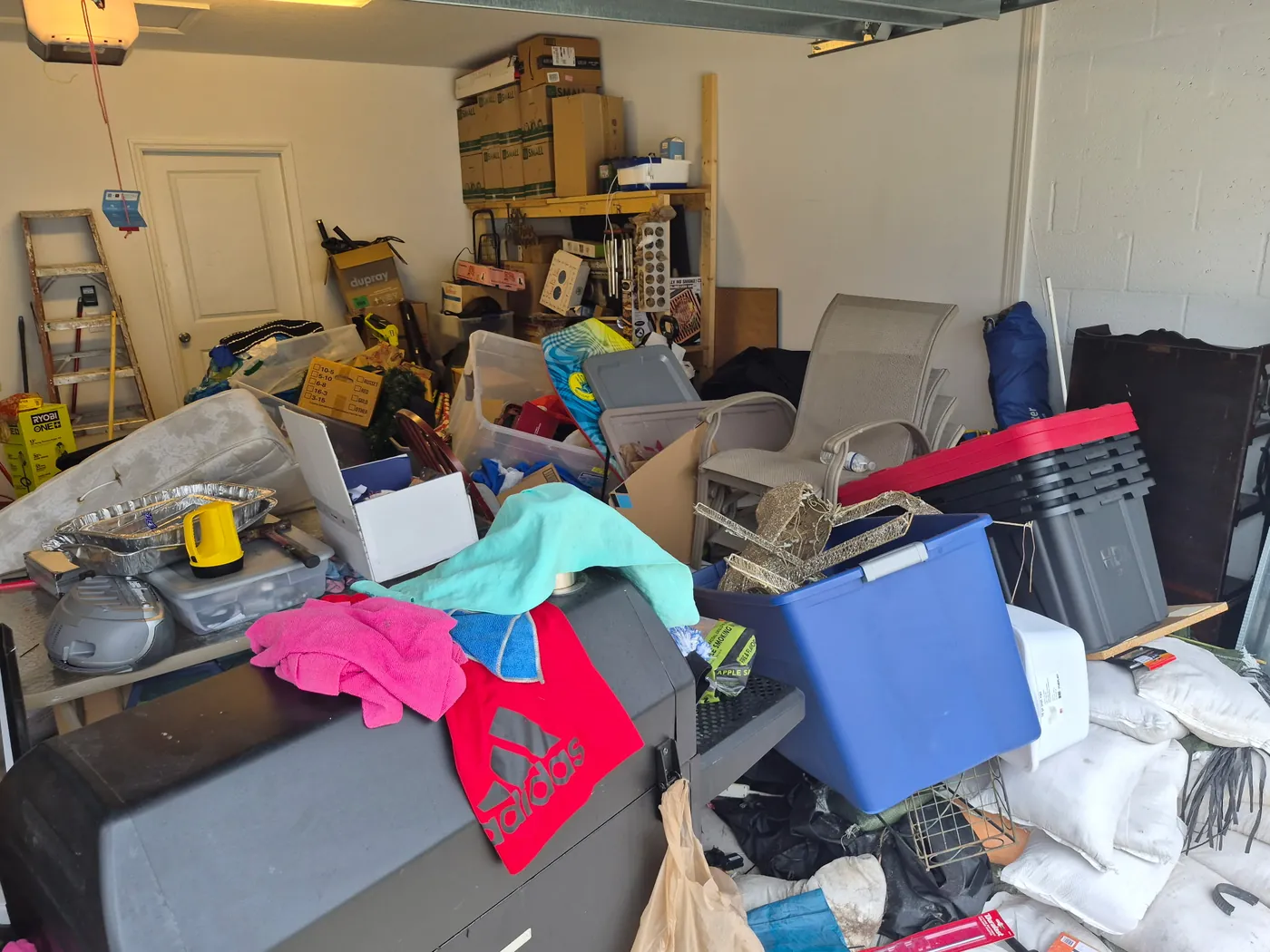 Garage floor coating before in Ruskin, FL — packed, impassable garage