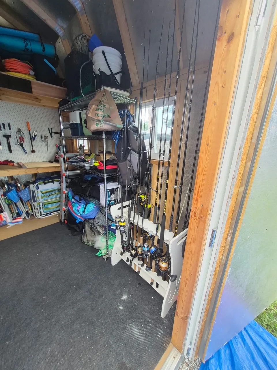 Shed organization after in Clearwater, FL — fishing rods and tools neatly racked