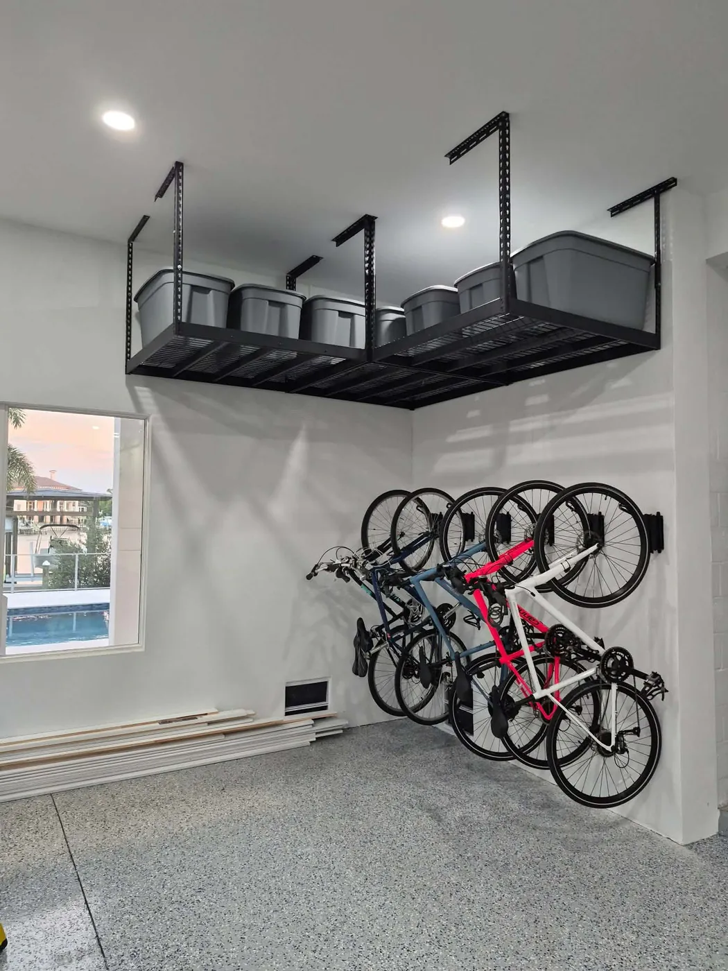Garage storage after in Ozona, FL — overhead racks and wall-mounted bike racks by Apex Garage & Exterior Solutions